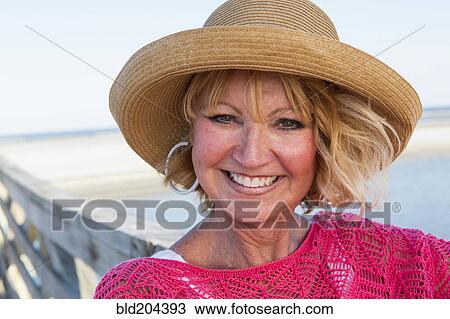 Stock Image - Caucasian woman smiling on beach. Fotosearch