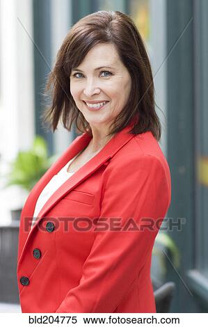 Stock Photography - Caucasian woman smiling on city street. Fotosearch