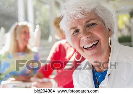 Caucasian woman smiling on porch View Large Photo Image Picture - Caucasian woman smiling on porch. Fotosearch
