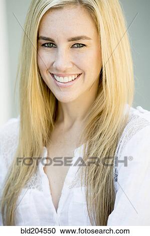 Stock Image - Caucasian woman smiling outdoors. Fotosearch