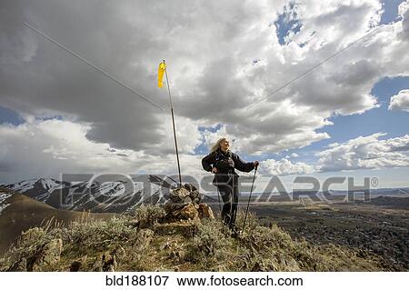 Caucasian woman standing on remote hilltop View Large Photo Image Stock Photo - Caucasian woman standing on remote hilltop. Fotosearch