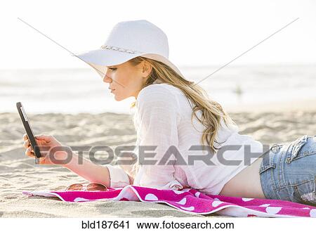 Caucasian woman using cell phone on beach View Large Photo Image Stock Image - Caucasian woman using cell phone on beach. Fotosearch