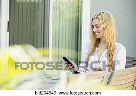 Caucasian woman using cell phone outdoors View Large Photo Image Stock Photo - Caucasian woman using cell phone outdoors. Fotosearch