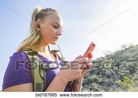 Caucasian woman using cell phone outdoors View Large Photo Image Stock Photography - Caucasian woman using cell phone outdoors. Fotosearch