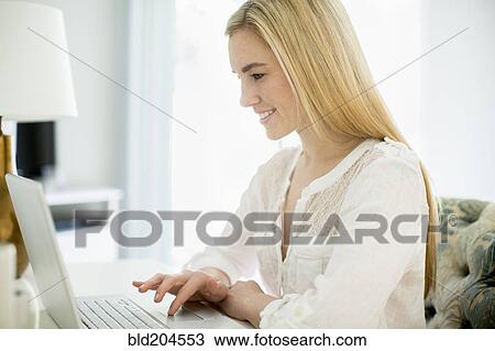 Stock Image - Caucasian woman using laptop. Fotosearch