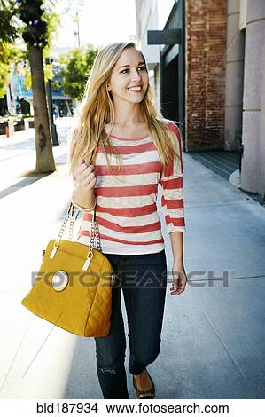 Caucasian woman walking on sidewalk View Large Photo Image Picture - Caucasian woman walking on sidewalk. Fotosearch