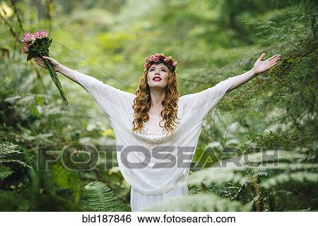 Caucasian woman wearing flower crown in forest View Large Photo Image Stock Photograph - Caucasian woman wearing flower crown in forest. Fotosearch