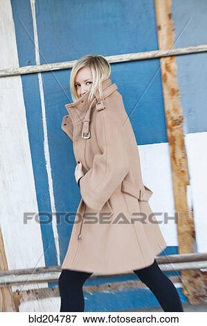 Caucasian woman wearing trenchcoat View Large Photo Image Stock Photo - Caucasian woman wearing trenchcoat. Fotosearch