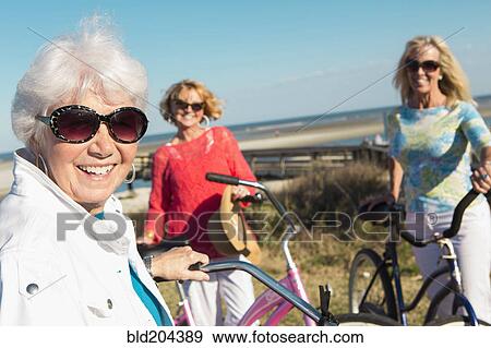 Caucasian women riding bicycles together View Large Photo Image Stock Photo - Caucasian women riding bicycles together. Fotosearch