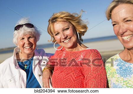 Caucasian women smiling on beach View Large Photo Image Picture - Caucasian women smiling on beach. Fotosearch
