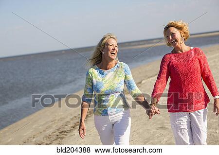 Caucasian women walking on beach View Large Photo Image Stock Photo - Caucasian women walking on beach. Fotosearch