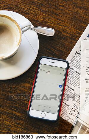 Cell phone, newspaper and coffee cup in cafe View Large Photo Image Stock Image - Cell phone, newspaper and coffee cup in cafe. Fotosearch