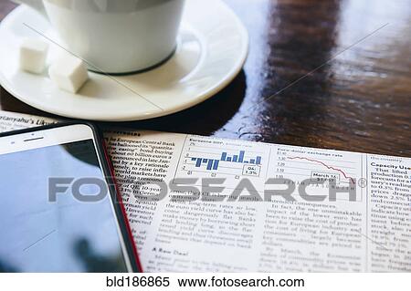 Cell phone, newspaper and coffee cup in cafe View Large Photo Image Stock Photography - Cell phone, newspaper and coffee cup in cafe. Fotosearch