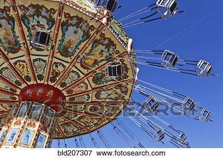 Chain swing ride against blue sky View Large Photo Image Stock Photo - Chain swing ride against blue sky. Fotosearch