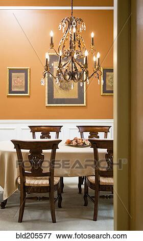 Stock Photo - Chandelier over luxury dining room table. Fotosearch
