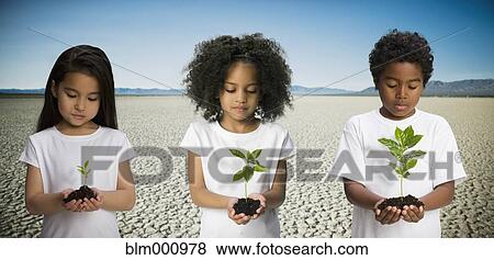 Children holding seedlings in desert View Large Photo Image Stock Photo - Children holding seedlings in desert. Fotosearch