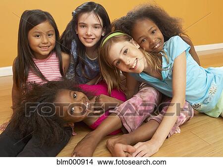 Picture - Children laying in pile and smiling. Fotosearch