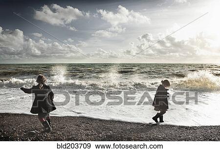 Children playing on rocky beach View Large Photo Image Stock Photo - Children playing on rocky beach. Fotosearch
