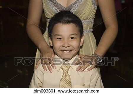 Chinese boy standing with mother View Large Photo Image Stock Image - Chinese boy standing with mother. Fotosearch