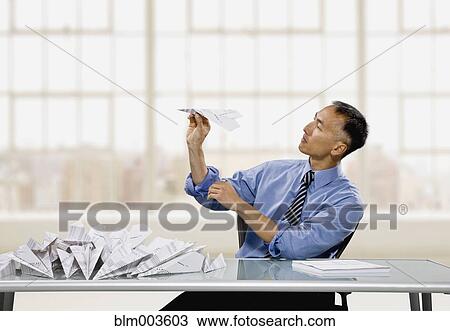 Chinese businessman throwing paper airplane View Large Photo Image Stock Image - Chinese businessman throwing paper airplane. Fotosearch