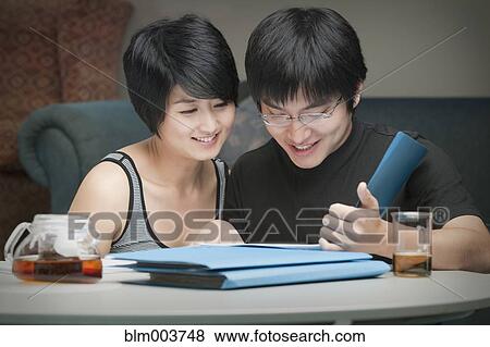 Chinese couple looking through folders View Large Photo Image Stock Photo - Chinese couple looking through folders. Fotosearch