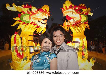 Stock Photograph - Chinese couple watching Chinese New Year's festival. Fotosearch