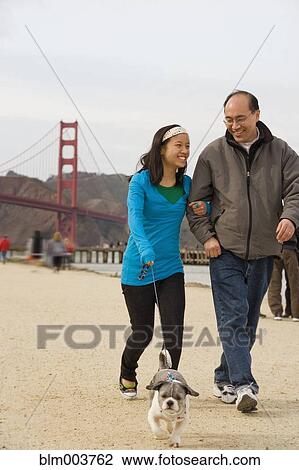 Chinese father and daughter walking dog View Large Photo Image Stock Image - Chinese father and daughter walking dog. Fotosearch