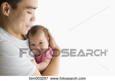 Stock Photo - Chinese father holding baby daughter. Fotosearch