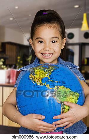 Stock Photograph - Chinese girl holding globe. Fotosearch