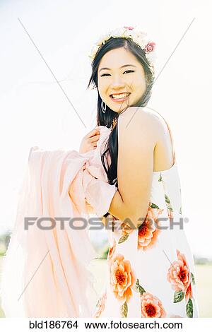 Picture - Chinese woman smiling outdoors. Fotosearch