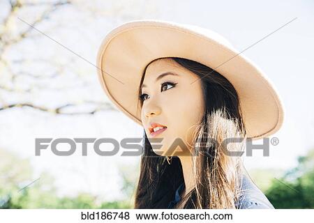 Chinese woman smiling outdoors View Large Photo Image Stock Photo - Chinese woman smiling outdoors. Fotosearch
