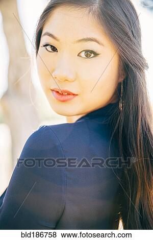 Stock Photo - Chinese woman smiling outdoors. Fotosearch