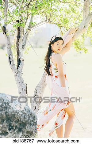 Chinese woman smiling outdoors View Large Photo Image Stock Photo - Chinese woman smiling outdoors. Fotosearch