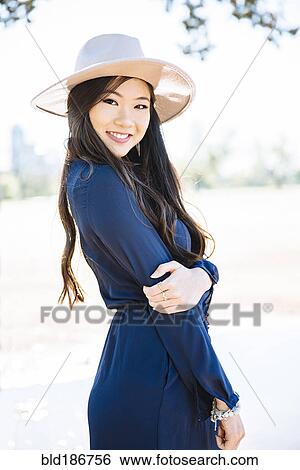 Chinese woman smiling outdoors View Large Photo Image Stock Photograph - Chinese woman smiling outdoors. Fotosearch