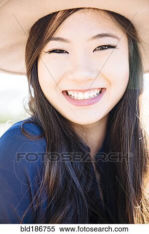 Stock Photography - Chinese woman smiling outdoors. Fotosearch