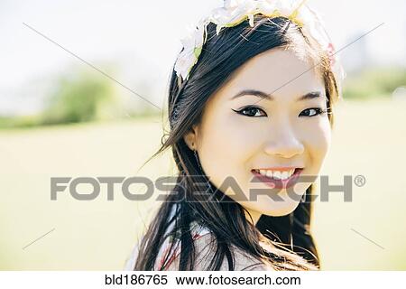 Stock Photography - Chinese woman smiling outdoors. Fotosearch