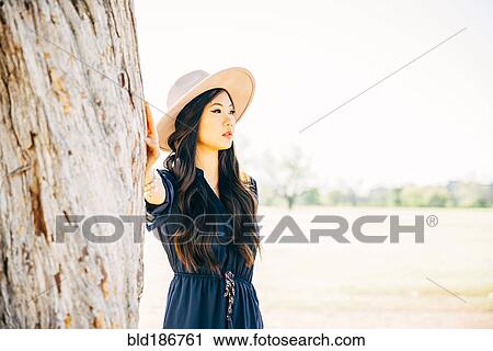 Chinese woman standing in field View Large Photo Image Stock Image - Chinese woman standing in field. Fotosearch