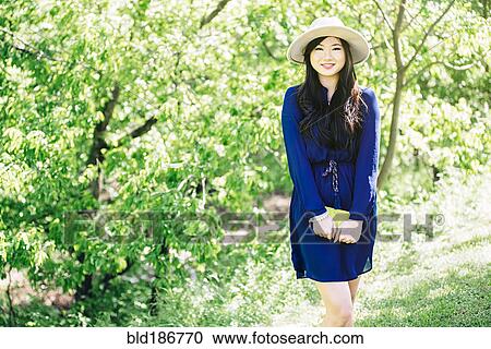 Chinese woman standing in garden View Large Photo Image Stock Image - Chinese woman standing in garden. Fotosearch