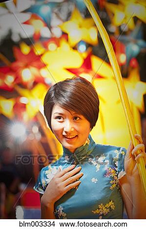 Picture - Chinese woman watching Chinese New Year's festival. Fotosearch