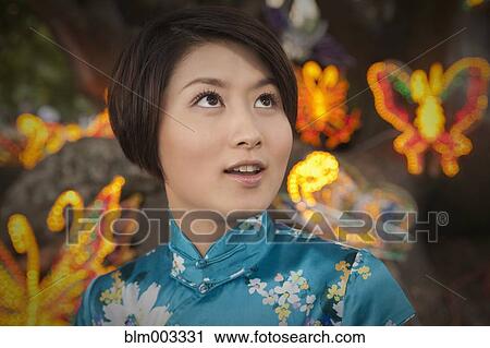 Stock Image - Chinese woman watching Chinese New Year's festival. Fotosearch