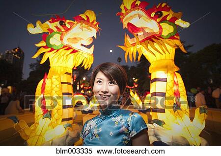 Stock Photography - Chinese woman watching Chinese New Year's festival. Fotosearch