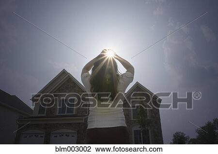 Chinese woman with arms raised looking at sun View Large Photo Image Stock Image - Chinese woman with arms raised looking at sun. Fotosearch