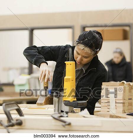 Picture - Chinese woman working in workshop. Fotosearch
