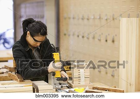 Stock Photography - Chinese woman working in workshop. Fotosearch