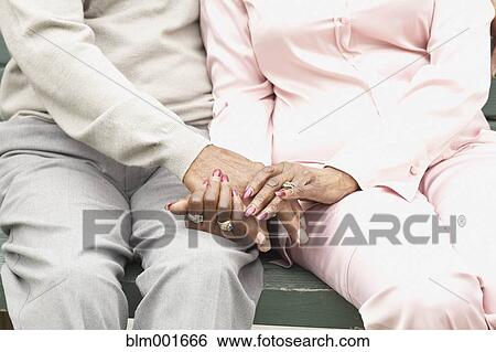 Close up of African couple holding hands View Large Photo Image Stock Photograph - Close up of African couple holding hands. Fotosearch