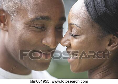 Stock Photography - Close up of African couple smiling at each other. Fotosearch