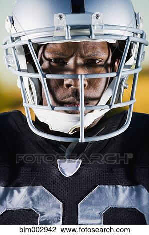 Stock Image - Close up of African football player in helmet. Fotosearch