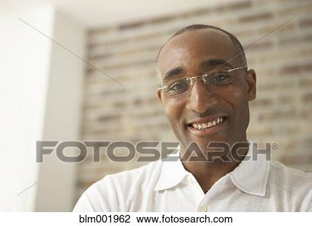 Close up of African man smiling and wearing eyeglasses View Large Photo Image Stock Image - Close up of African man smiling and wearing eyeglasses. Fotosearch