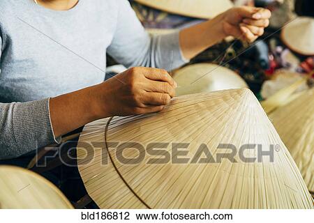 Close up of artisan weaving straw hat View Large Photo Image Stock Image - Close up of artisan weaving straw hat. Fotosearch