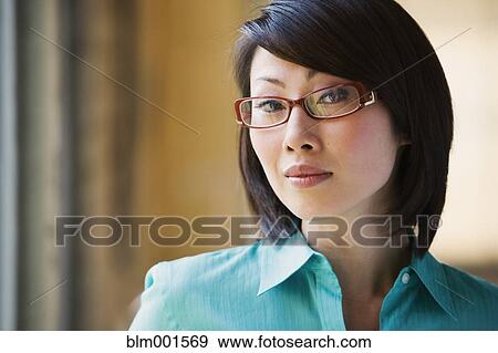Close up of Asian woman wearing eyeglasses View Large Photo Image Stock Photo - Close up of Asian woman wearing eyeglasses. Fotosearch